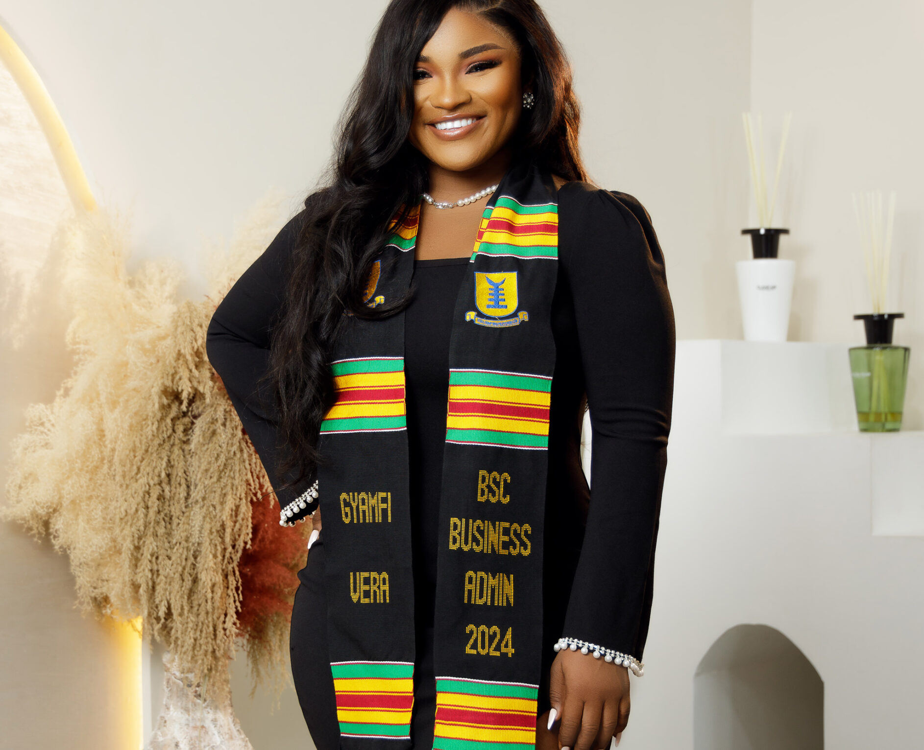 Business Administration graduate wearing a personalized Kente Graduation Stole