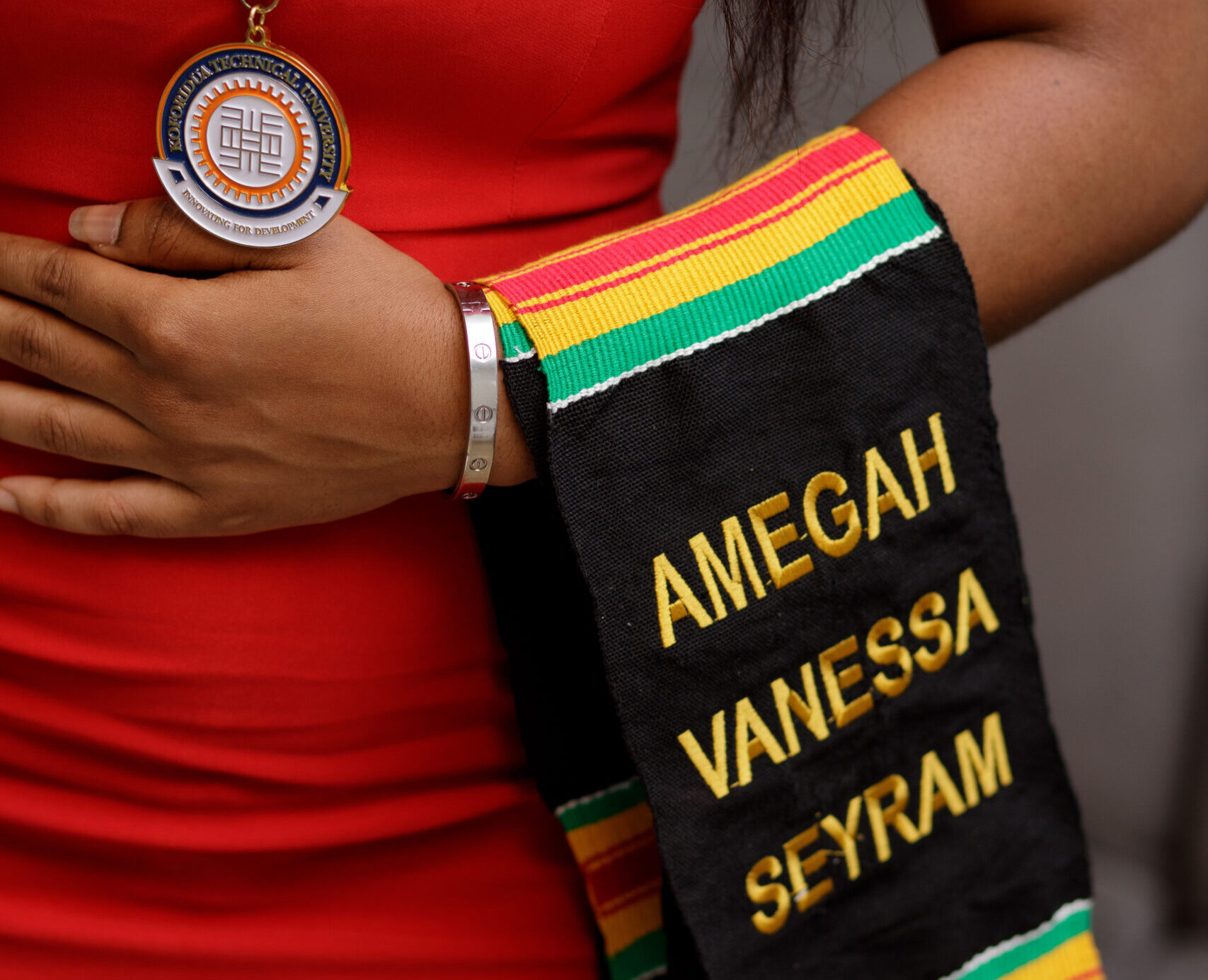 Close-up of a personalized Kente Graduation Stole with embroidered name