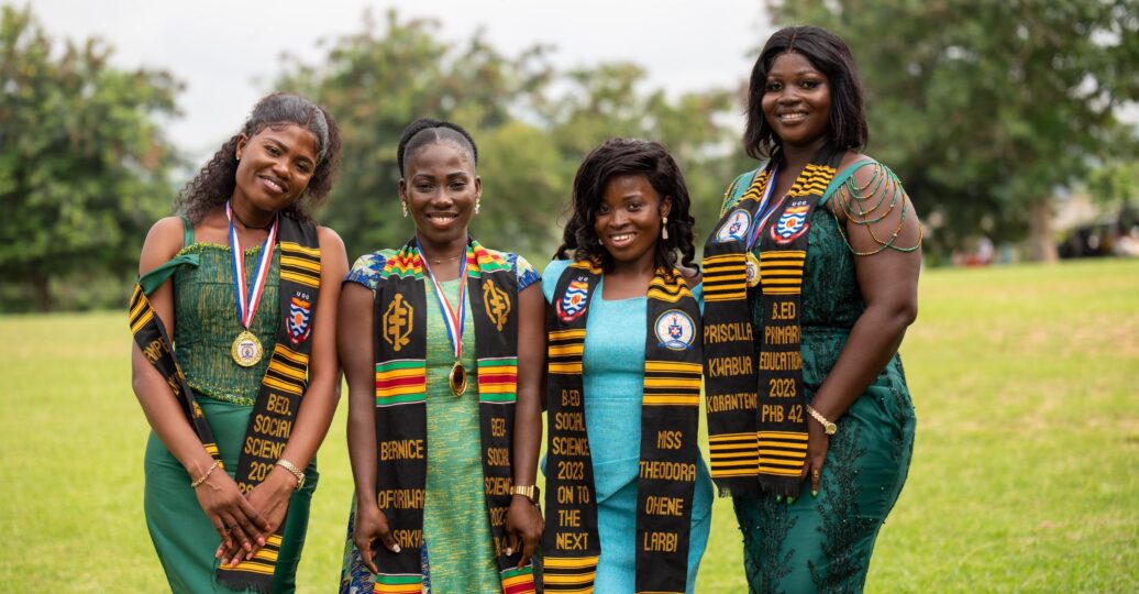Group of graduates wearing African Kente Graduation Stoles on campus